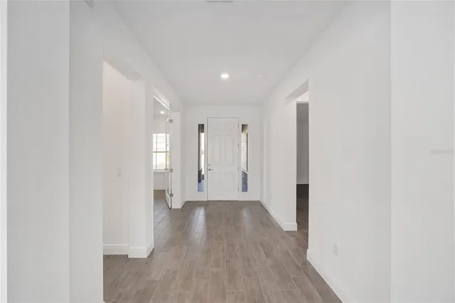 a view of a hallway with wooden floor