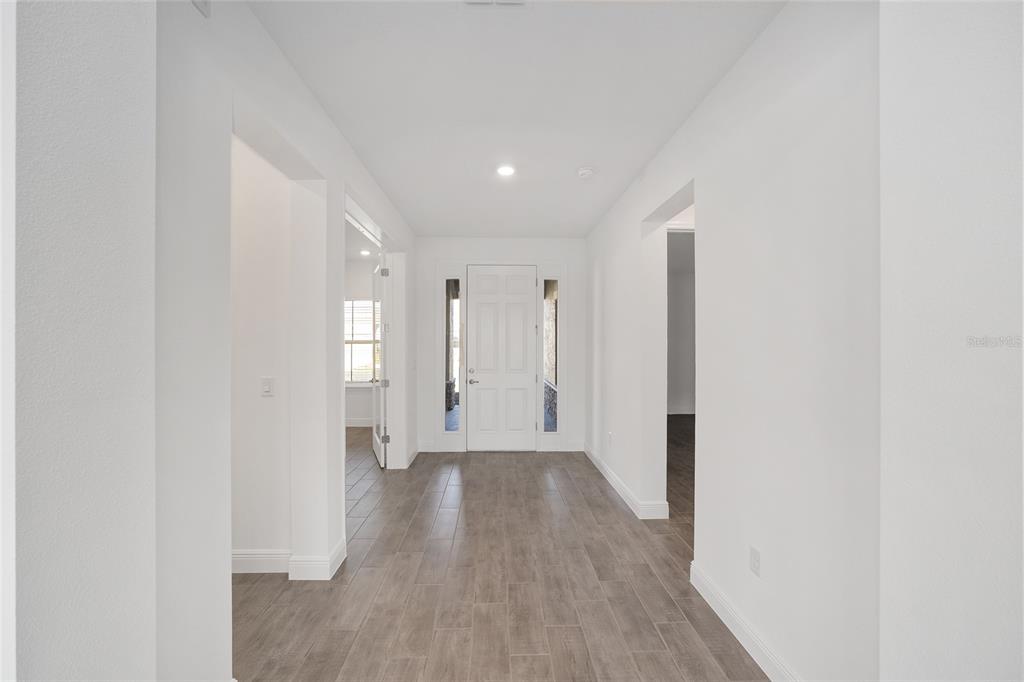 10104 Southwest 106th Circle Ocala, FL 34481 - Photo 10 of 47 a view of a hallway with wooden floor