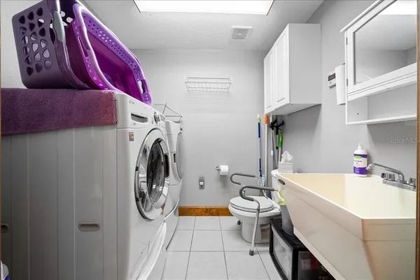 a large kitchen with kitchen island granite countertop lots of counter space and a sink
