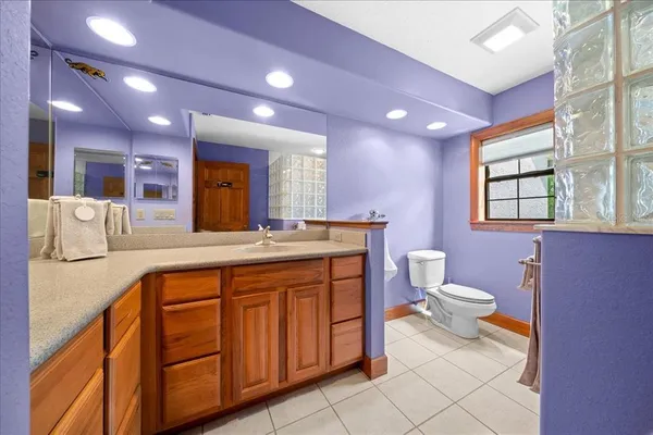 a living room with furniture and a ceiling fan