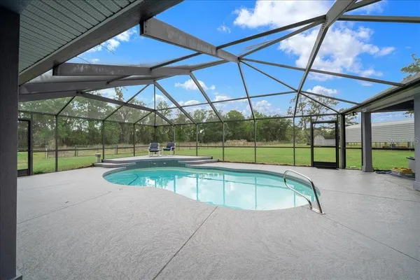a view of a patio with table and chairs