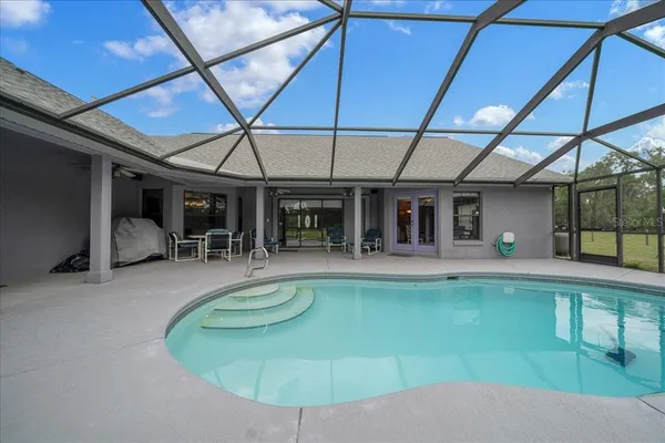 an aerial view of residential houses with outdoor space and trees all around