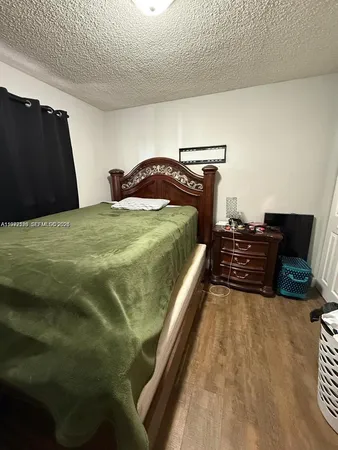 a bedroom with a bed and dresser