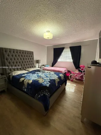 a bedroom with a bed chair and window