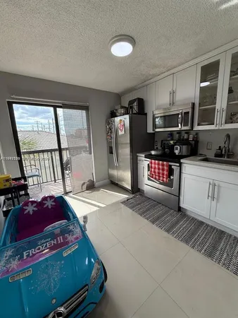 a kitchen with refrigerator and cabinets