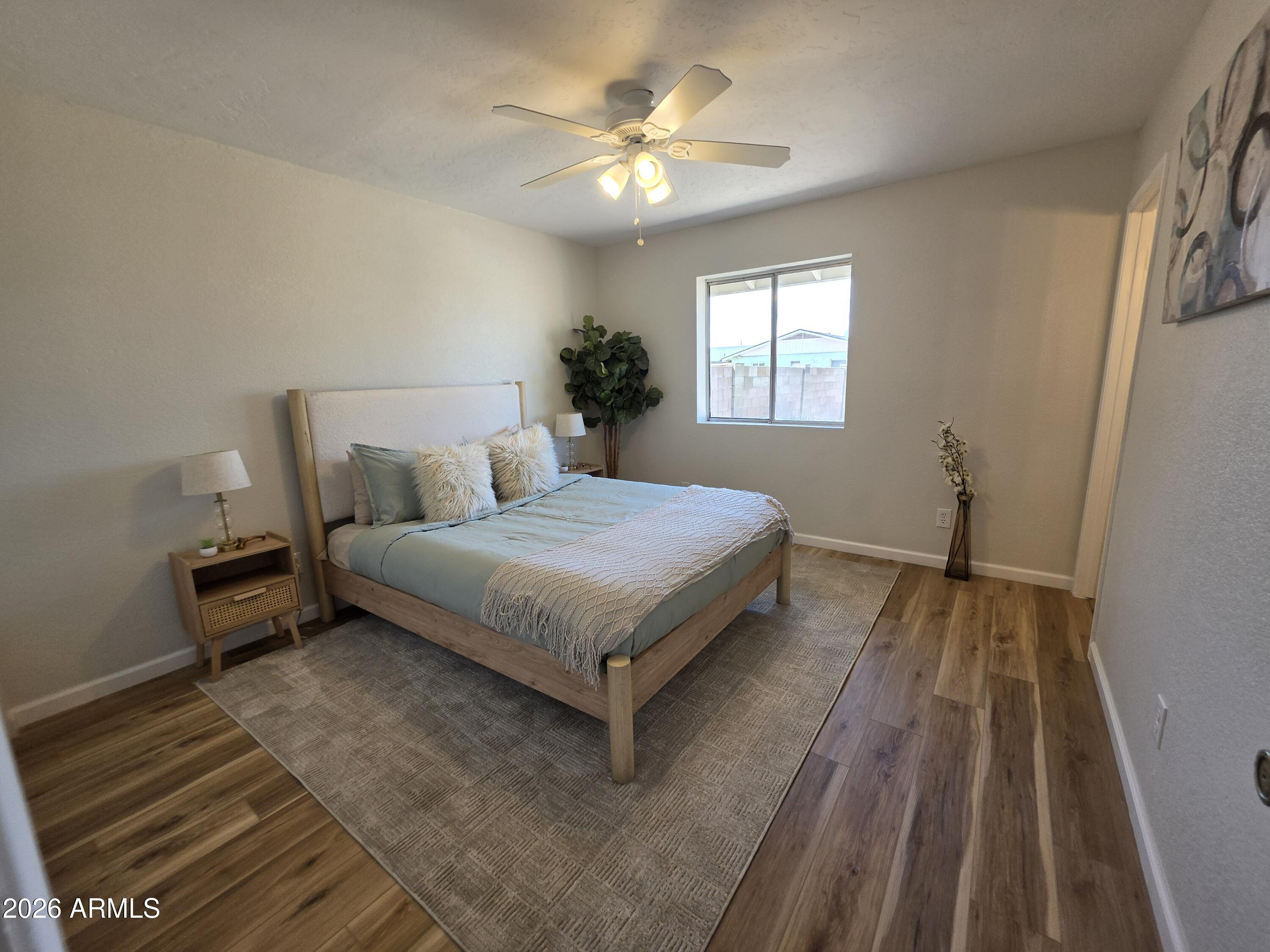 46 East McLellan Road Mesa, AZ 85201 - Photo 7 of 18 a bedroom with a bed and a potted plant