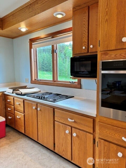 40 Turner Homestead Road Oroville, WA 98844 - Photo 7 of 27 a kitchen with stainless steel appliances granite countertop a stove a sink and a microwave