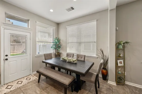 a view of a dining room with furniture and window