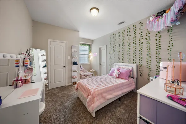 a bedroom with a bed and a couch
