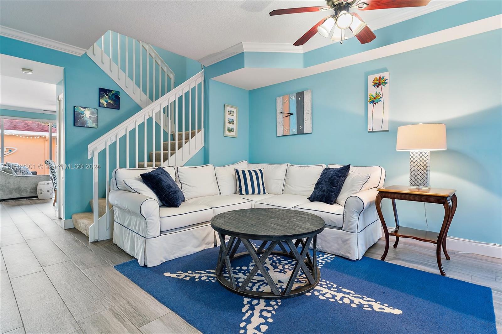 136 Milbridge Drive Jupiter, FL 33458 - Photo 12 of 50 a living room with furniture a rug and a chandelier