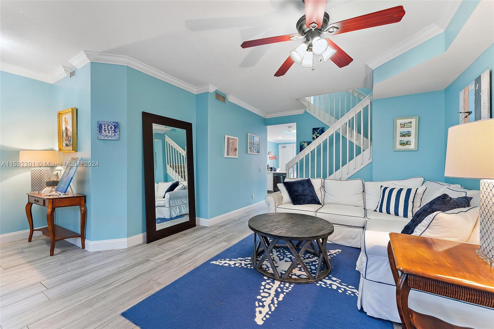 136 Milbridge Drive Jupiter, FL 33458 - Photo 13 of 50 a living room with furniture a rug and a chandelier
