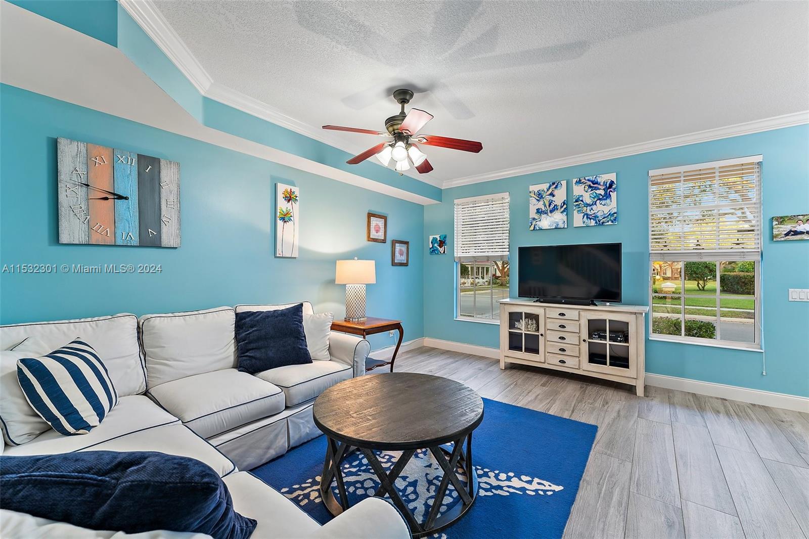136 Milbridge Drive Jupiter, FL 33458 - Photo 14 of 50 a living room with furniture a flat screen tv and wooden floor