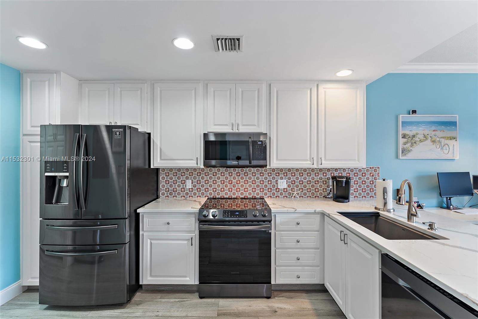 136 Milbridge Drive Jupiter, FL 33458 - Photo 16 of 50 a kitchen with a refrigerator stove and sink