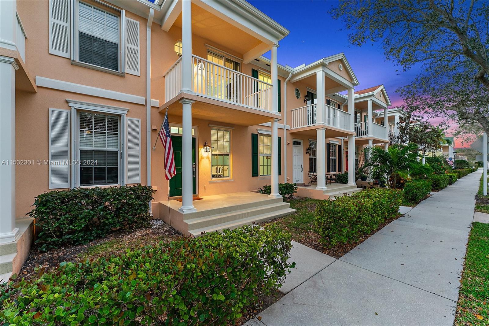 136 Milbridge Drive Jupiter, FL 33458 - Photo 2 of 50 front view of a brick house with a yard