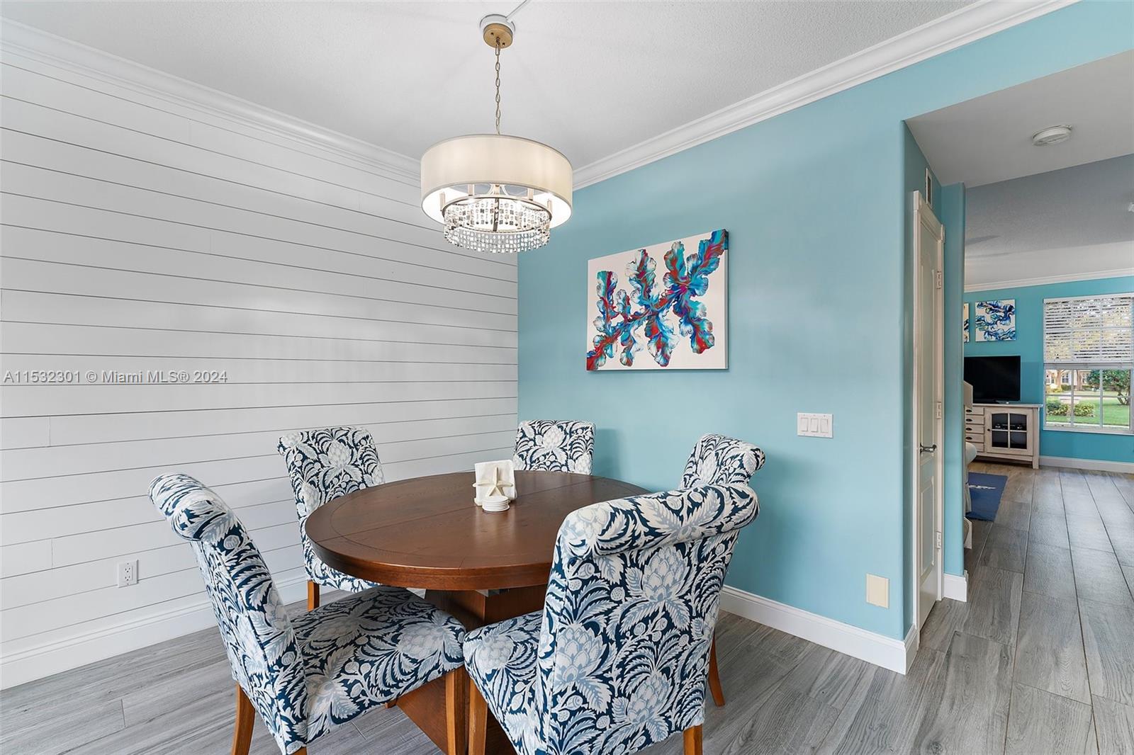 136 Milbridge Drive Jupiter, FL 33458 - Photo 22 of 50 a view of a dining room with furniture wooden floor and chandelier