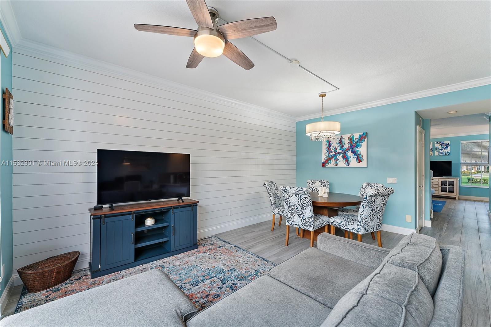 136 Milbridge Drive Jupiter, FL 33458 - Photo 25 of 50 a living room with furniture and a flat screen tv