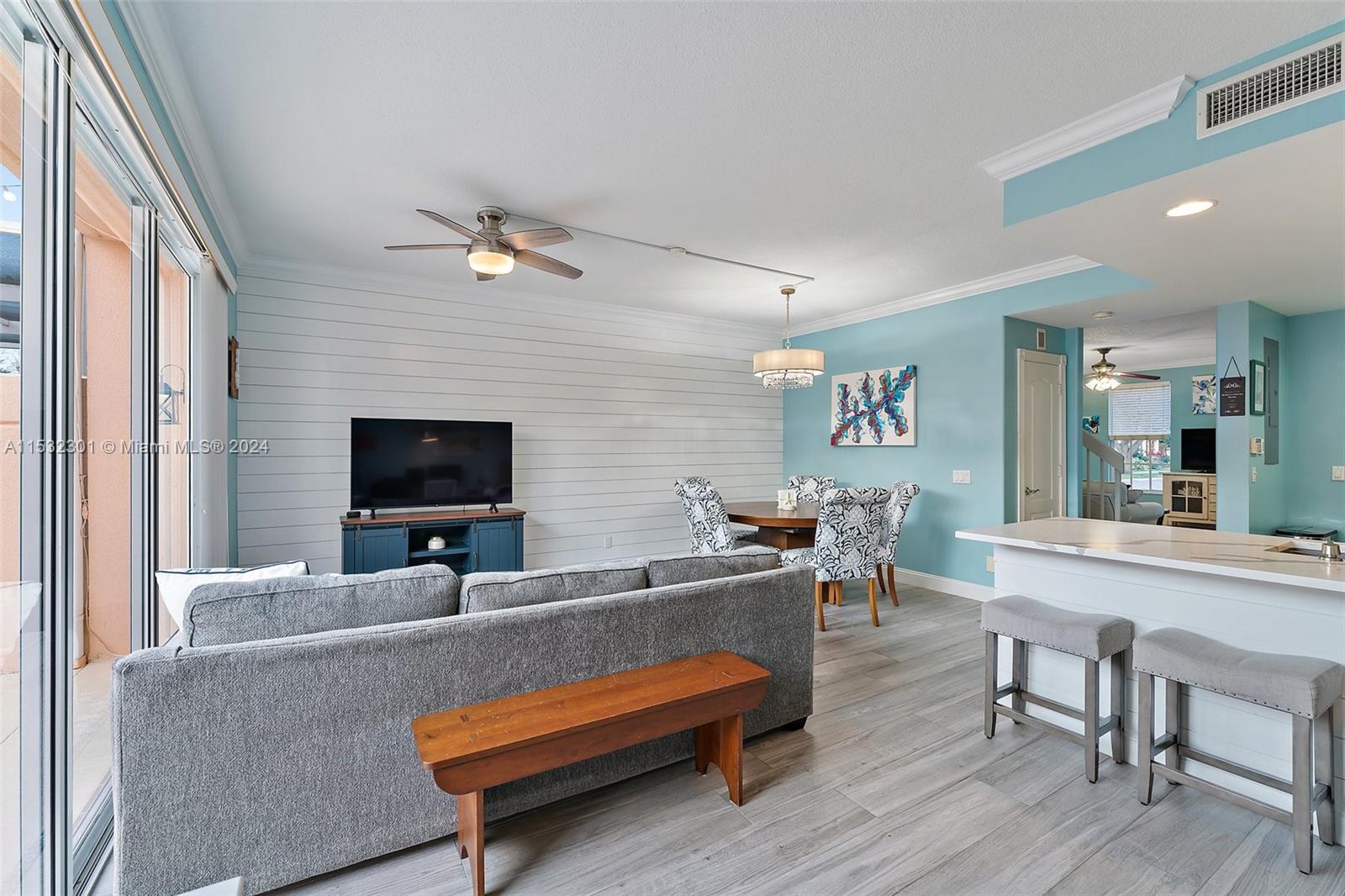 136 Milbridge Drive Jupiter, FL 33458 - Photo 27 of 50 a living room with furniture and a flat screen tv