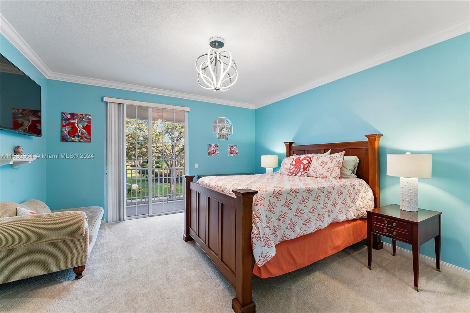 136 Milbridge Drive Jupiter, FL 33458 - Photo 28 of 50 a bedroom with a bed and a chandelier