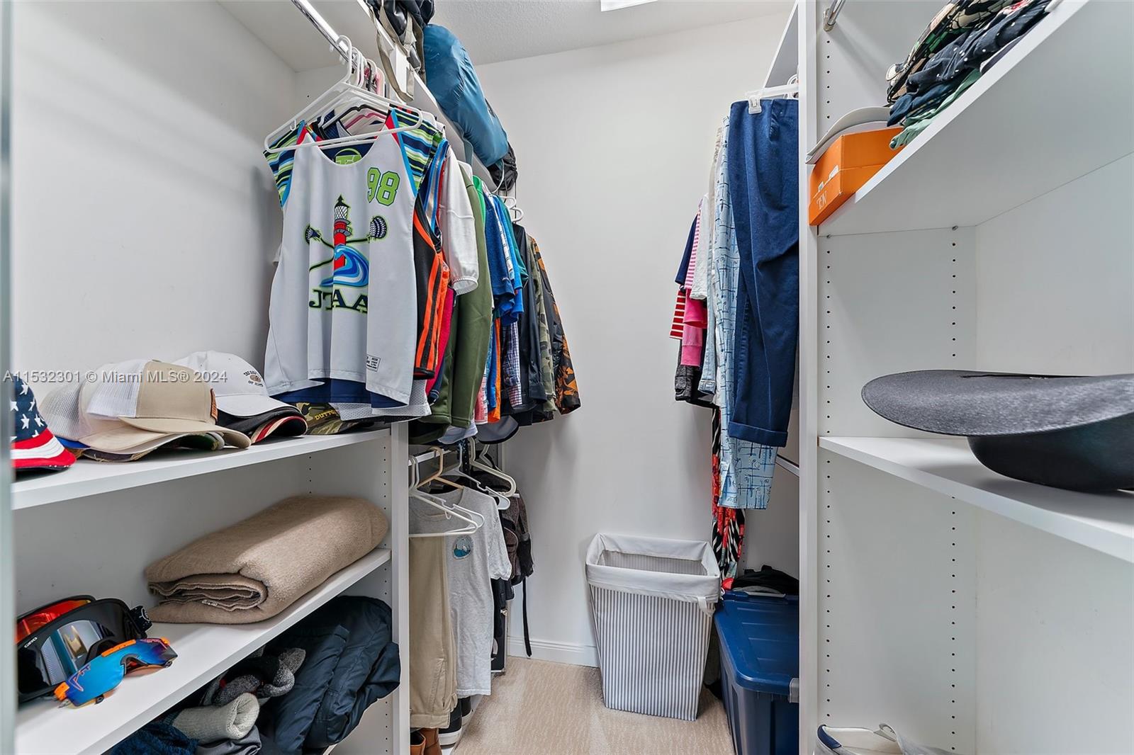136 Milbridge Drive Jupiter, FL 33458 - Photo 38 of 50 a view of walk in closet with clothes and shoes