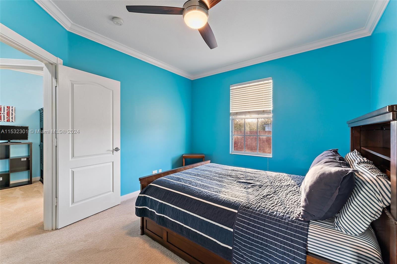 136 Milbridge Drive Jupiter, FL 33458 - Photo 39 of 50 a bedroom with a bed and a chandelier