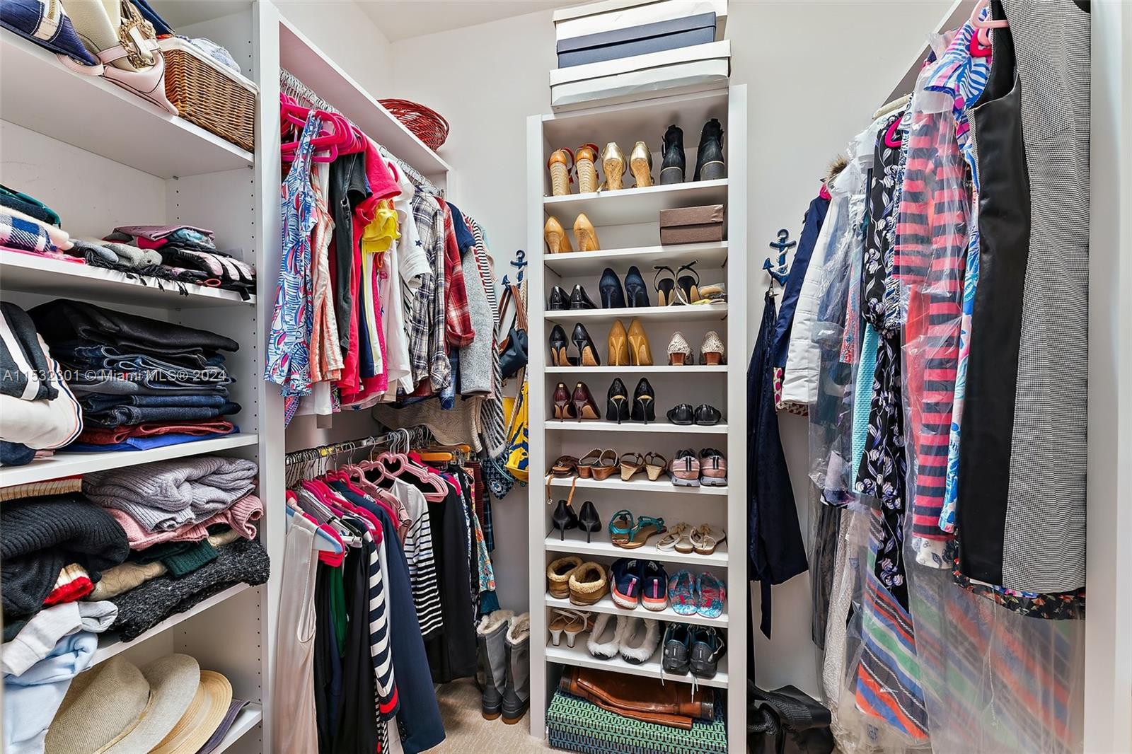 136 Milbridge Drive Jupiter, FL 33458 - Photo 42 of 50 a view of walk in closet with clothes and shoes