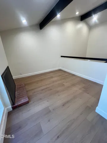 a view of a room with wooden floor