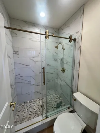 a bathroom with a toilet and shower