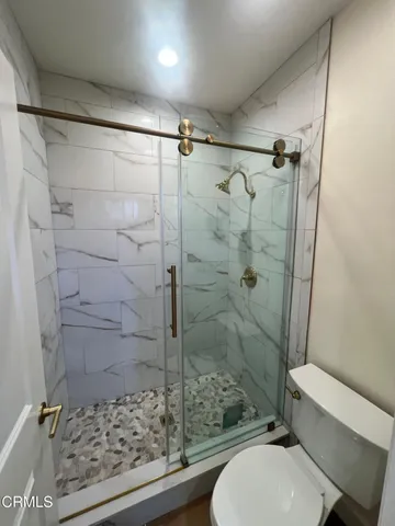 a bathroom with a toilet and shower