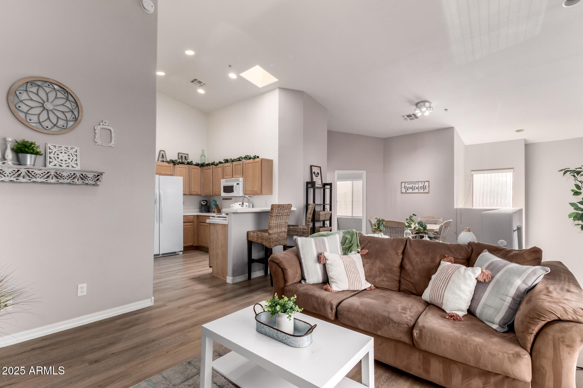 a living room with furniture kitchen and a table