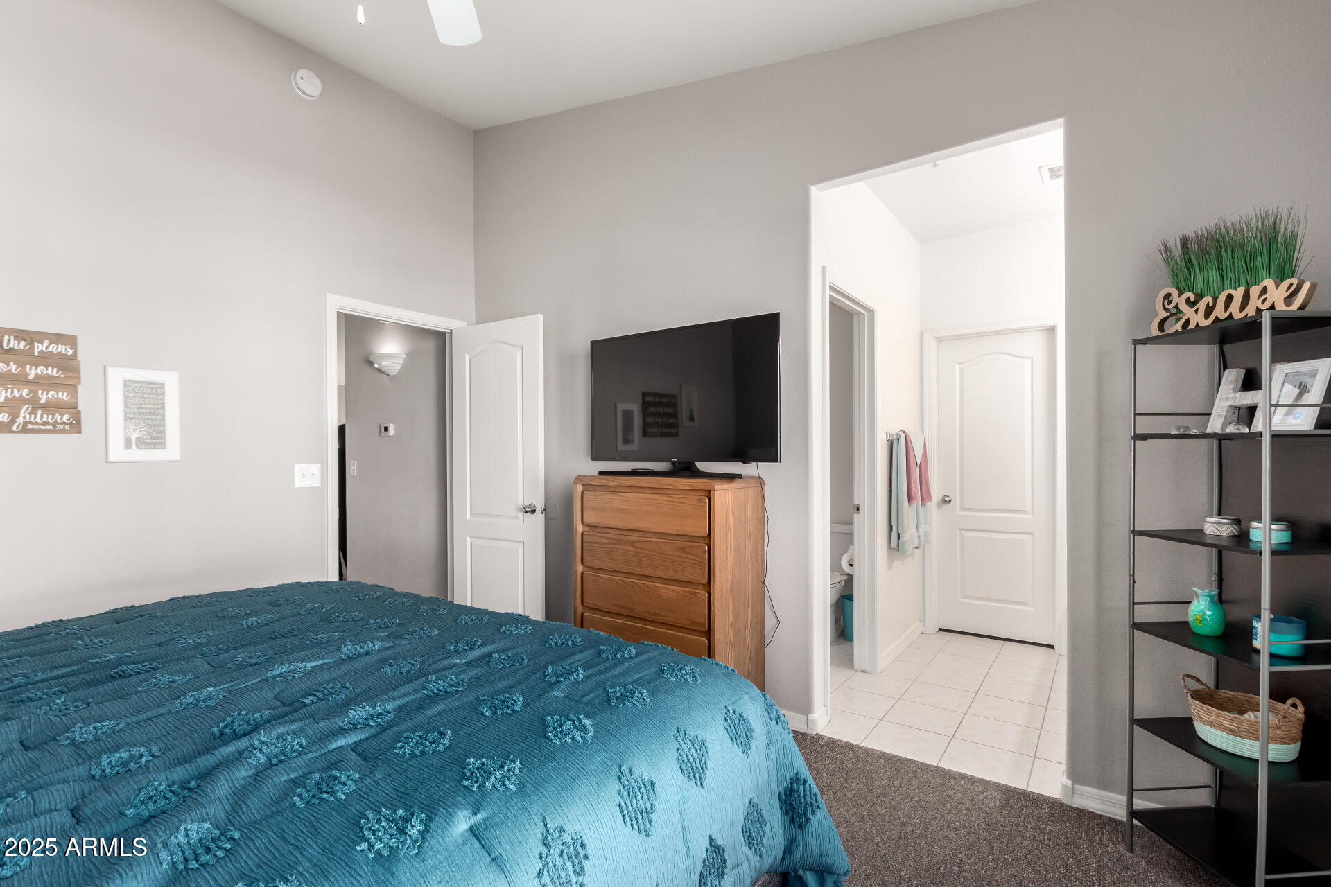 1406 West Emerald Avenue, Unit 102 Mesa, AZ 85202 - Photo 11 of 21 a bedroom with a bed and a flat screen tv