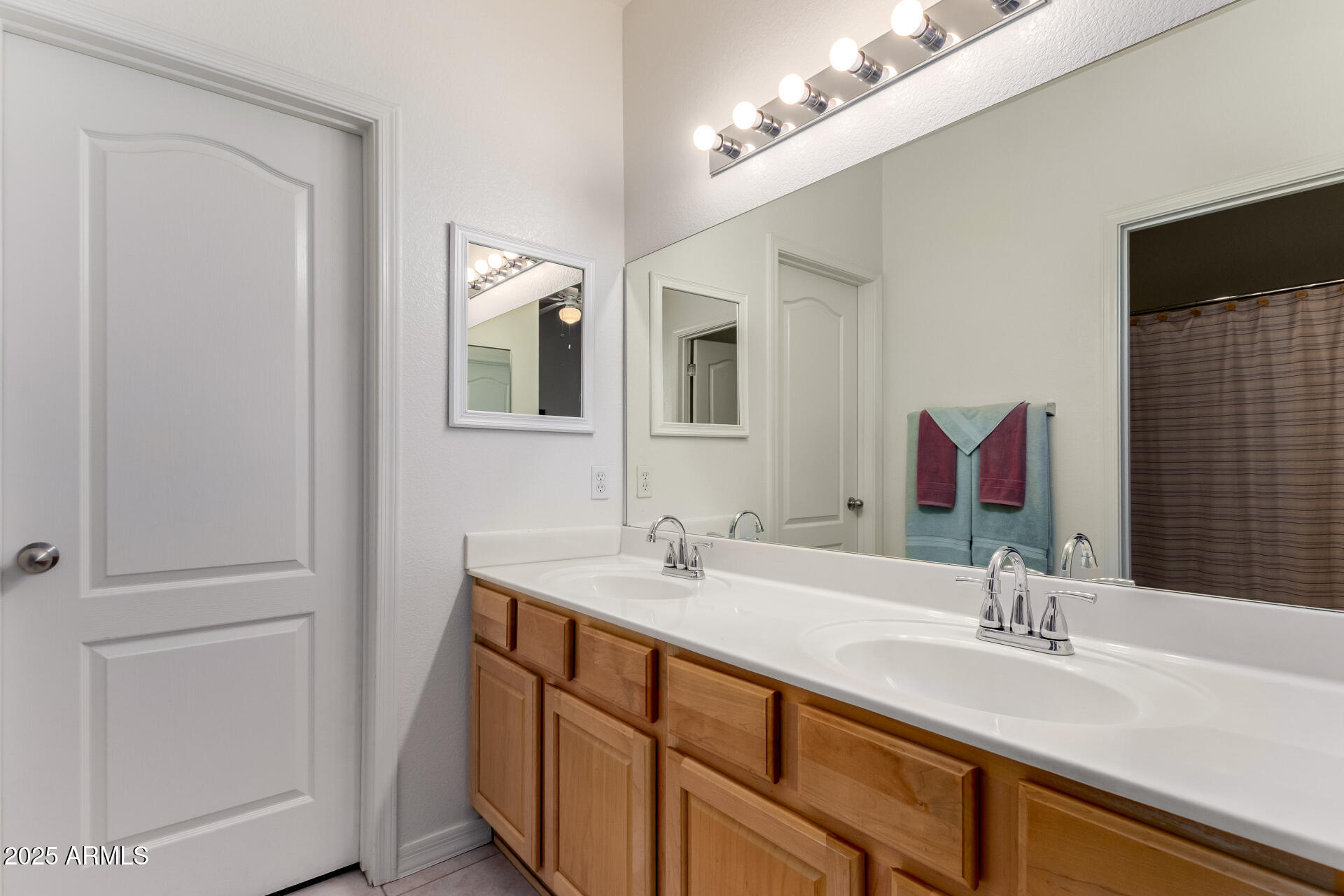 1406 West Emerald Avenue, Unit 102 Mesa, AZ 85202 - Photo 12 of 21 a bathroom with a double vanity sink and a mirror