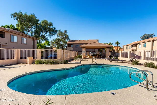 a view of a swimming pool with lounge chairs