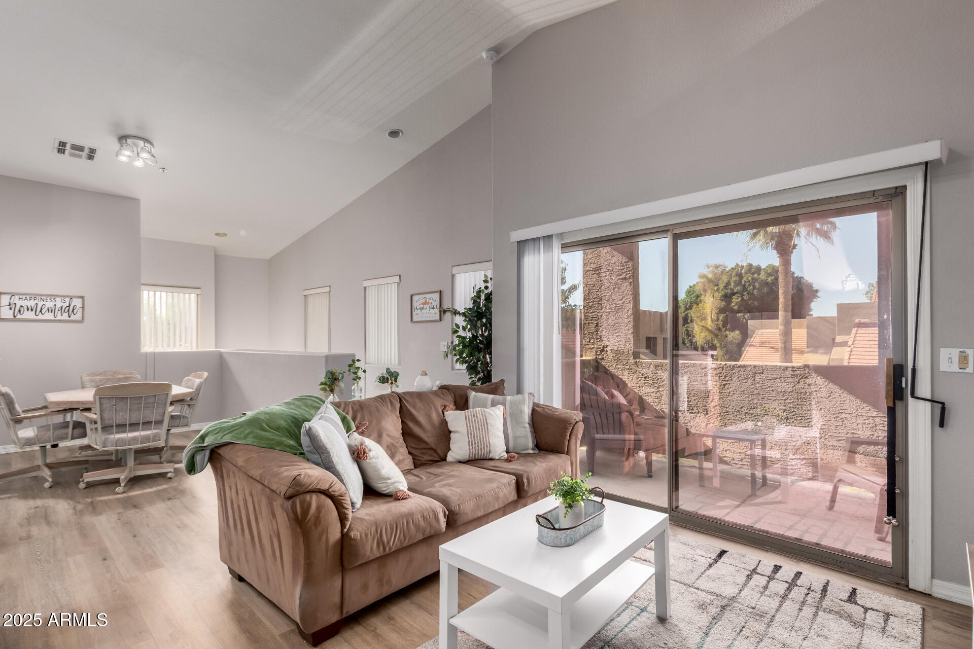 1406 West Emerald Avenue, Unit 102 Mesa, AZ 85202 - Photo 2 of 21 a living room with furniture and a large window