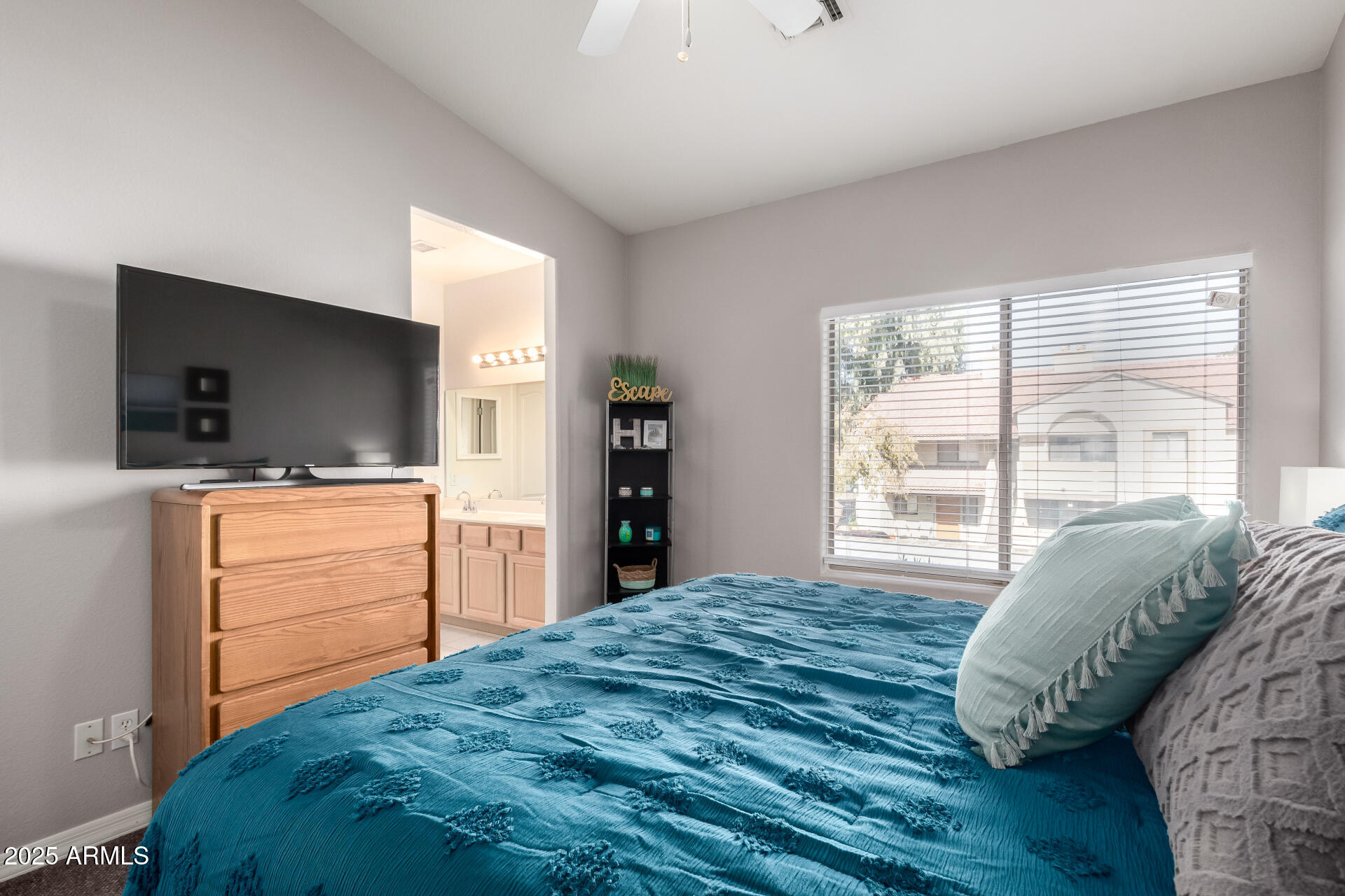 1406 West Emerald Avenue, Unit 102 Mesa, AZ 85202 - Photo 9 of 21 a bedroom with a bed and flat screen tv