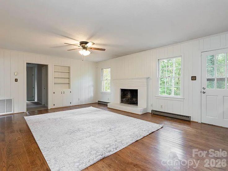 852 Fieldstone Road Mooresville, NC 28115 - Photo 5 of 13 an empty room with windows and fireplace