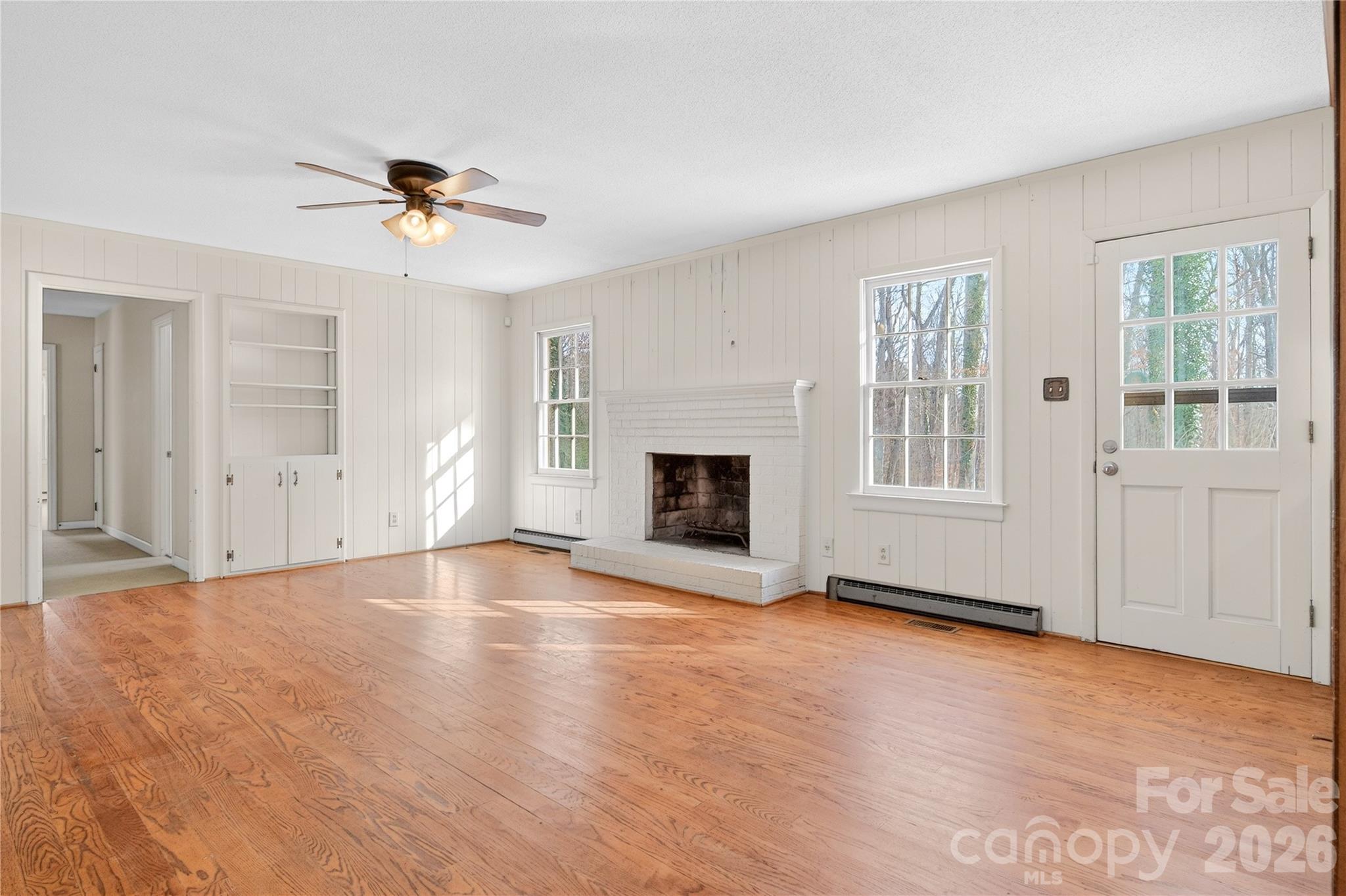 852 Fieldstone Road Mooresville, NC 28115 - Photo 8 of 34 a view of an empty room with a fireplace and a window