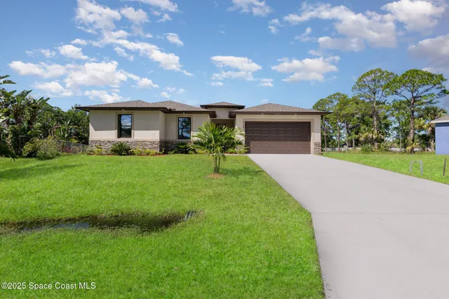 a front view of house with yard and green space