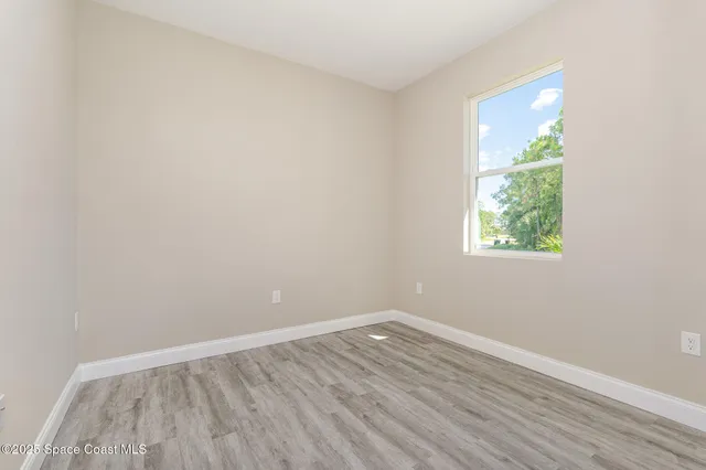 a view of an empty room with storage and utility