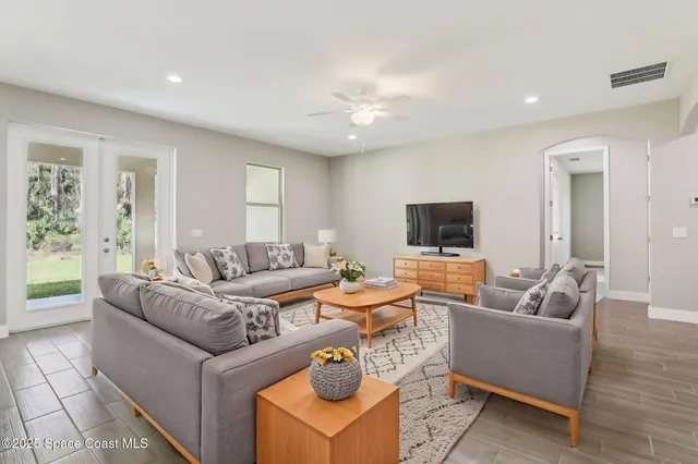 a dining room with furniture and wooden floor