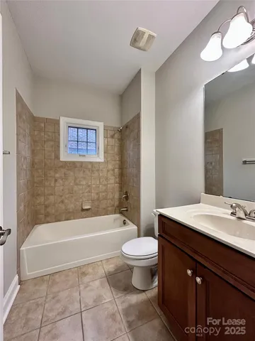 a bathroom with a sink a toilet and bathtub