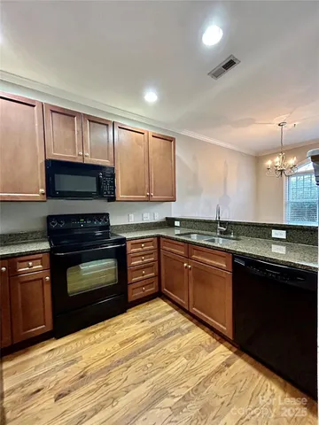 a kitchen with stainless steel appliances granite countertop a stove cabinets and a sink