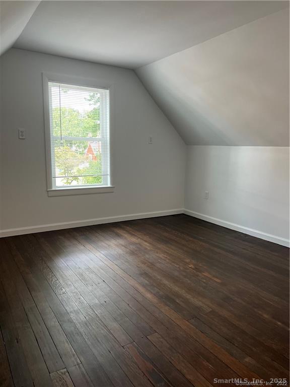 144 Rakoczy Avenue Fairfield, CT 06824 - Photo 11 of 19 an empty room with wooden floor and windows