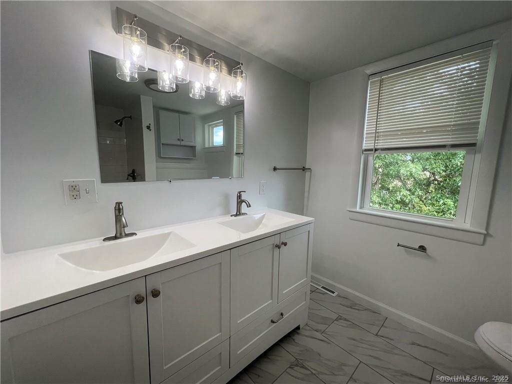 144 Rakoczy Avenue Fairfield, CT 06824 - Photo 13 of 19 a bathroom with a sink and a mirror