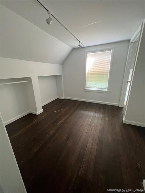 144 Rakoczy Avenue Fairfield, CT 06824 - Photo 14 of 19 an empty room with wooden floor and windows