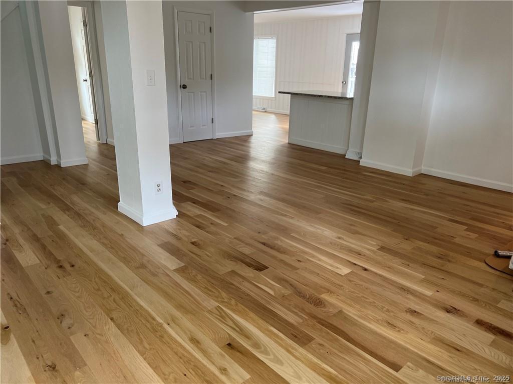 144 Rakoczy Avenue Fairfield, CT 06824 - Photo 17 of 19 a view of a livingroom with wooden floor
