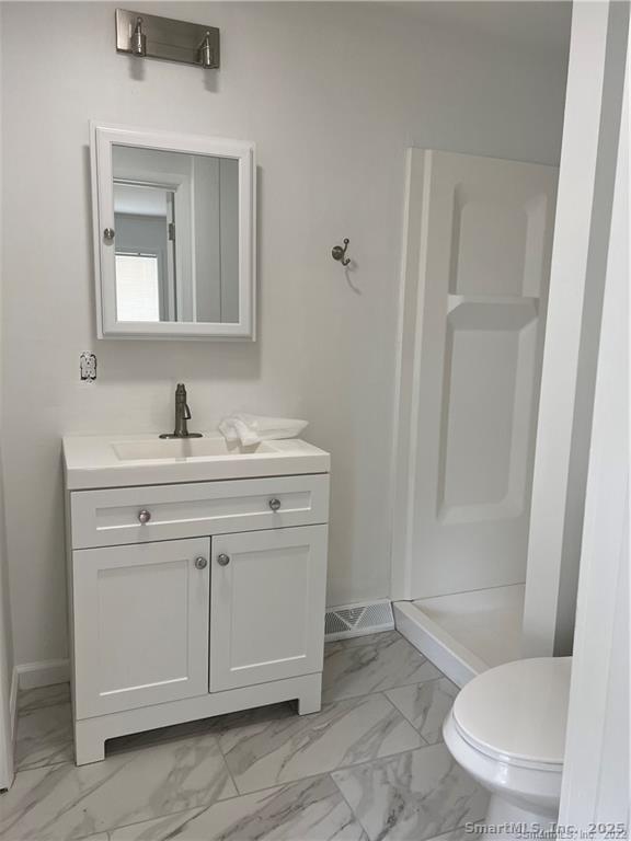 144 Rakoczy Avenue Fairfield, CT 06824 - Photo 9 of 19 a bathroom with a sink a toilet and shower
