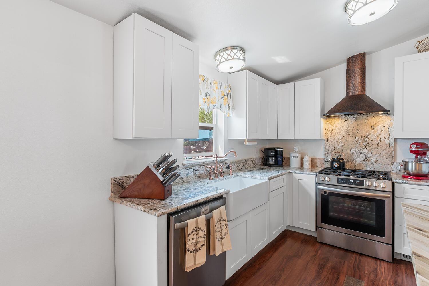 1400 West Marlette Street, Unit 45 Ione, CA 95640 - Photo 13 of 41 a kitchen with stainless steel appliances granite countertop a stove a sink and a white cabinets with wooden floor