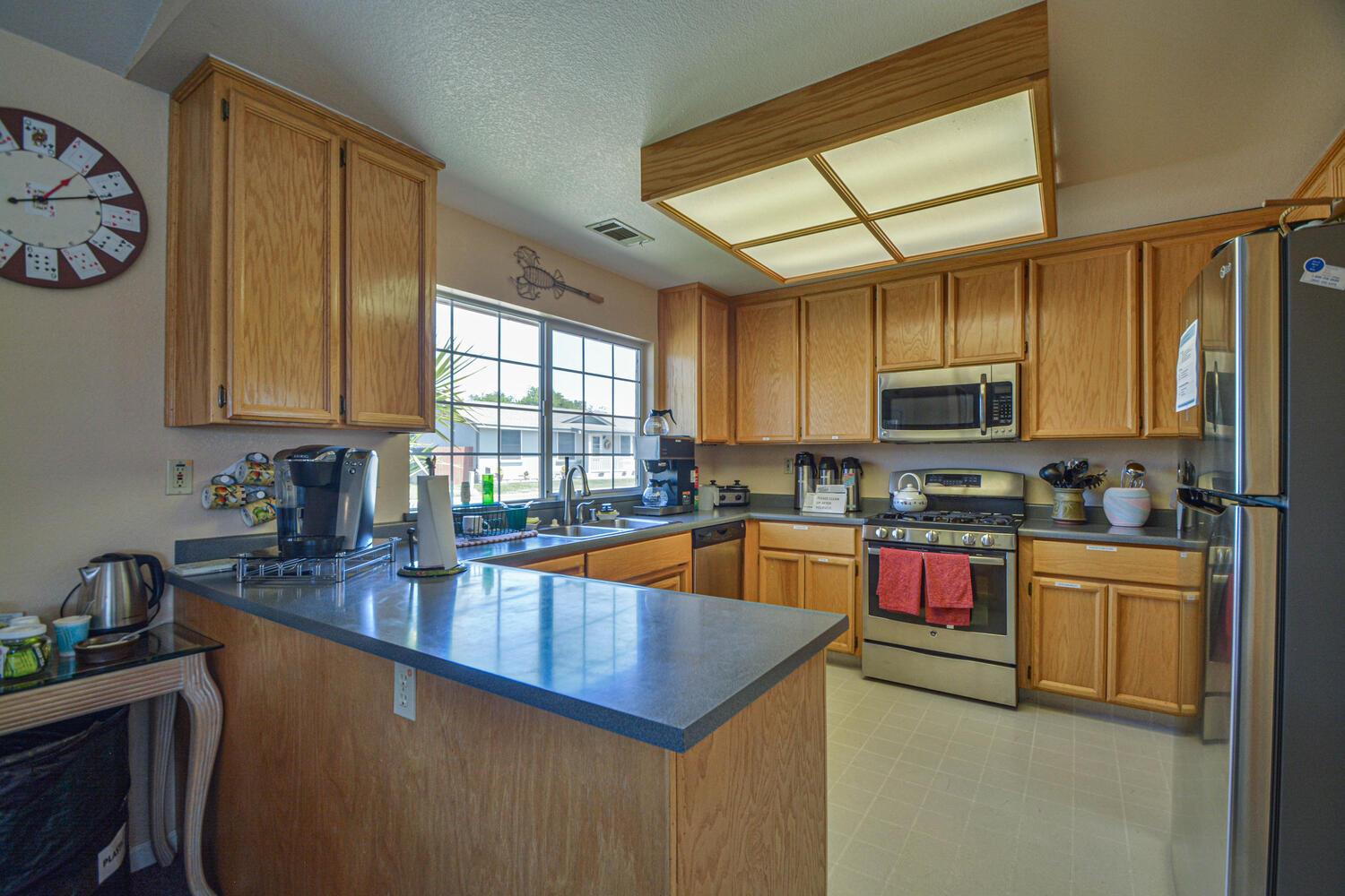 1400 West Marlette Street, Unit 45 Ione, CA 95640 - Photo 37 of 41 a kitchen with stainless steel appliances granite countertop a sink a stove top oven a counter space and cabinets