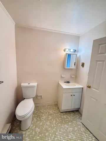 a bathroom with a toilet a sink and mirror