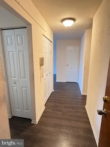 a view of a hallway with wooden floor